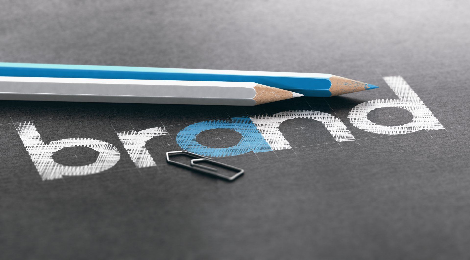 Your employment brand drives the attraction of top performers. Blue and white pencil sitting on black paper with the word Brand written.