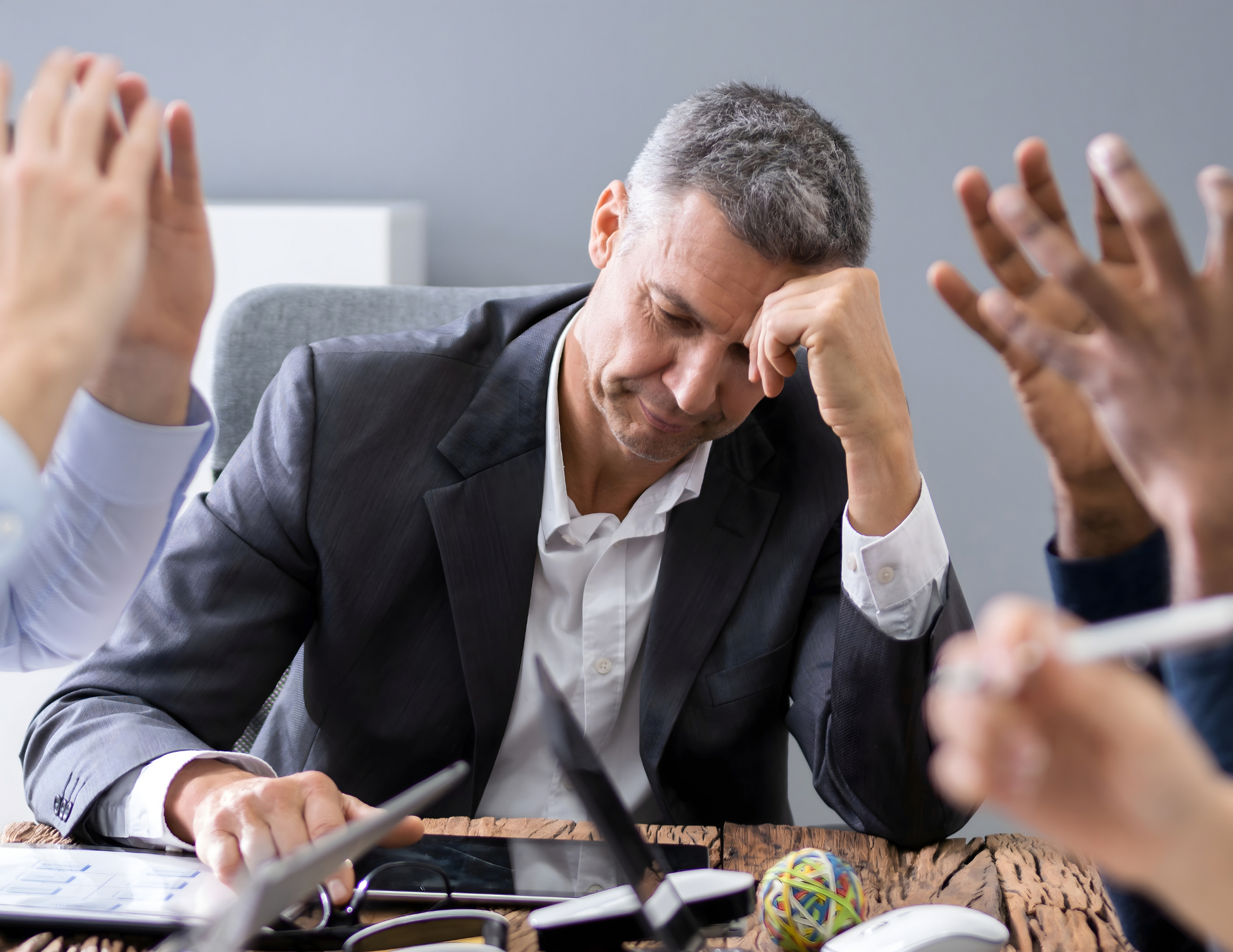 Improve your culture - improve your meeting effectiveness. Frustrated business leader in the middle of a contentious meeting caused by culture problems