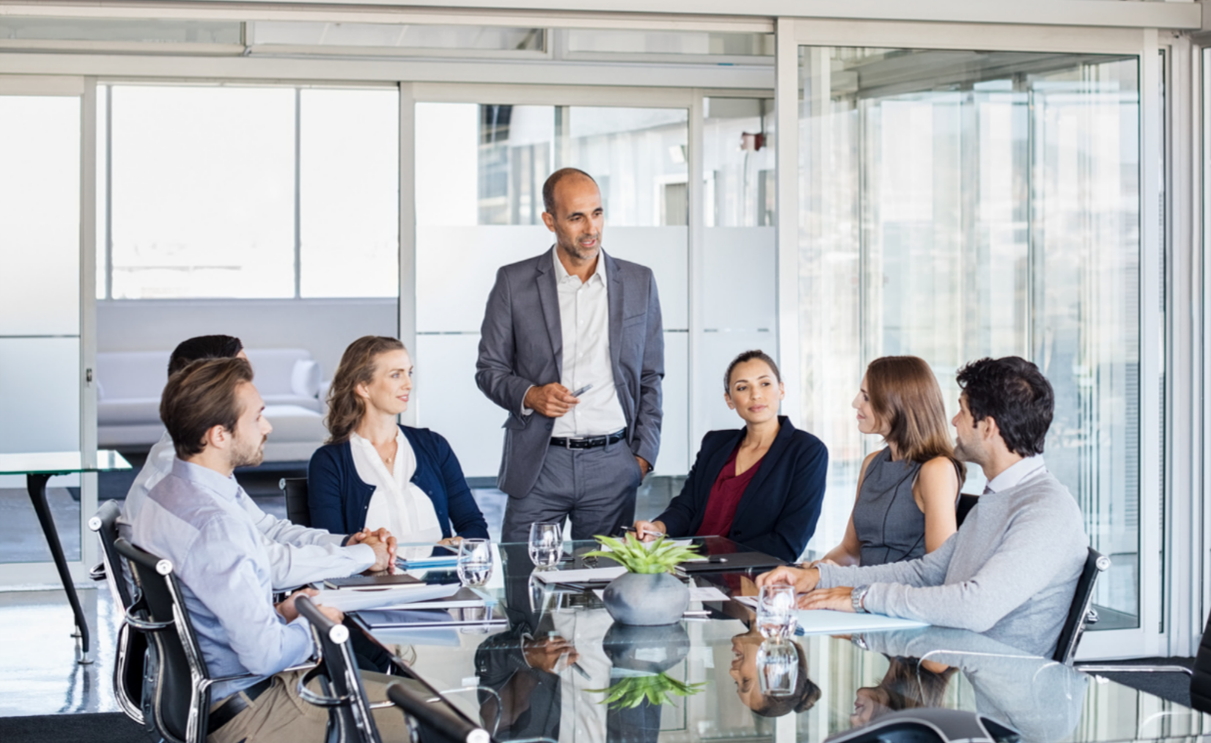 Executive team sitting around a conference table.