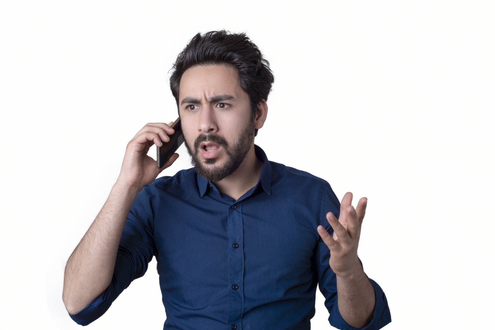 Middle-aged man with bewildered and frustrated expression talking on cell phone.