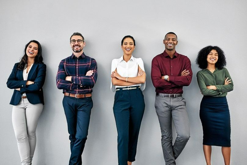 Effective HR Strategies include a rich focus on culture development. Five confident employees standing side-by-side.
