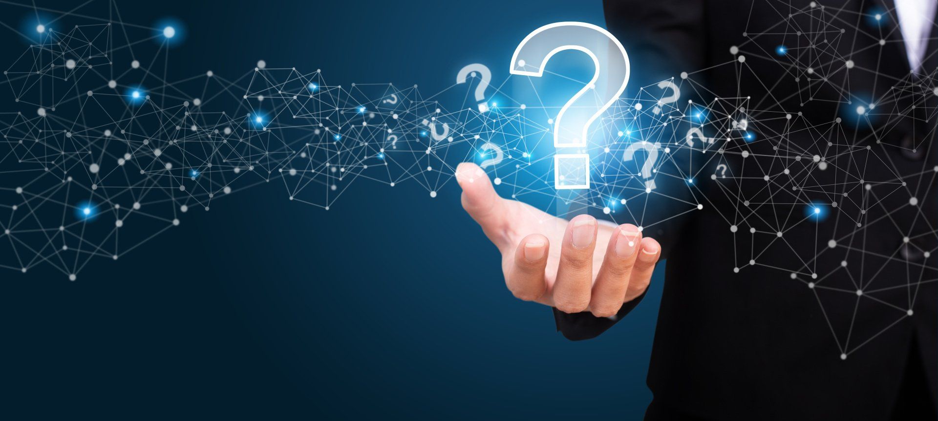 HR teams must understand the businesses they support. Here are twenty questions that can help. Outstretched hand holding brightly lit question mark in front of a dark background.