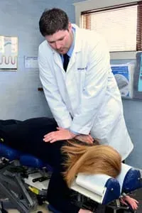 Chiropractor Dr. Matt houchin giving a woman a chiropractic adjustment