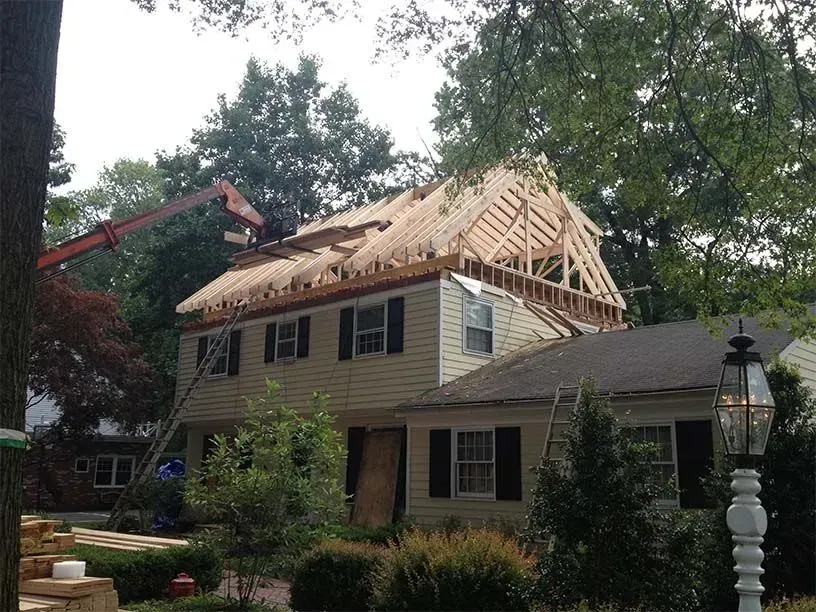 A house under construction with a crane in the background