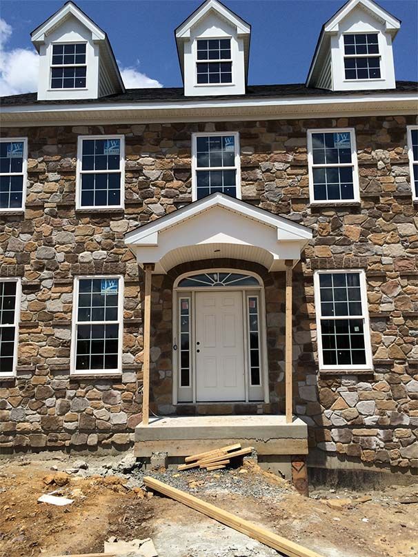 A stone building with a white door and windows