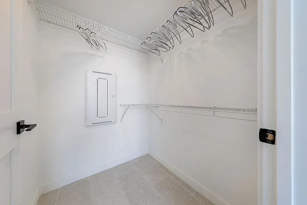 Spacious walk-in closet with ample shelving and storage space, perfect for organizing your wardrobe.
