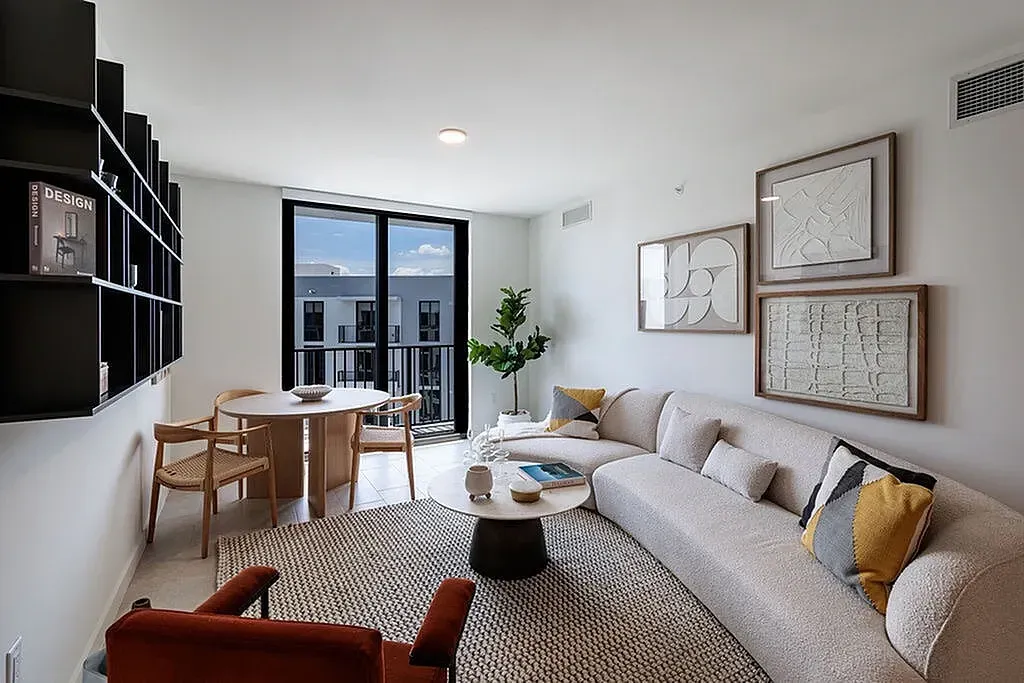Enjoy everyday comfort in this contemporary living room with sleek porcelain tile flooring and expansive windows with natural lighting.