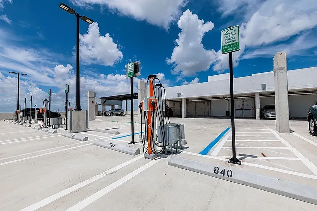 Modern parking lot featuring onsite electric vehicle charging stations.