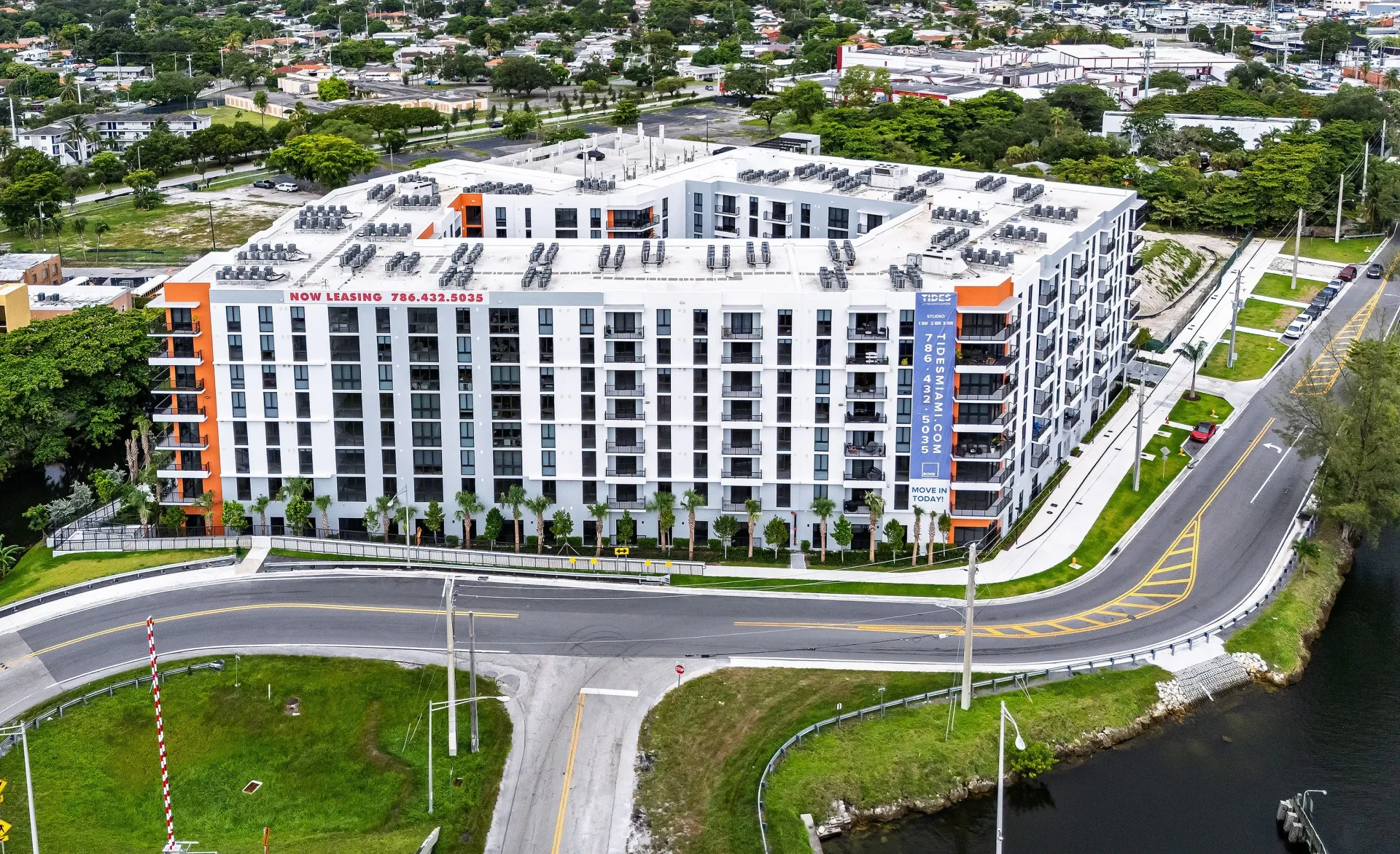 Tides at River Rapids boasts sleek architecture and vibrant accents, surrounded by picturesque waterway.