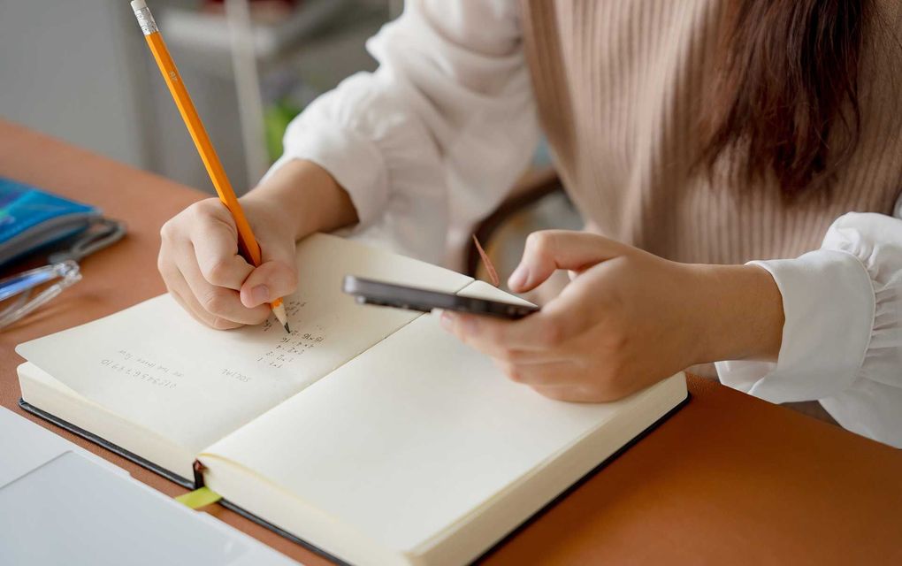 Subject Tutoring - student doing exam hand holding pencil