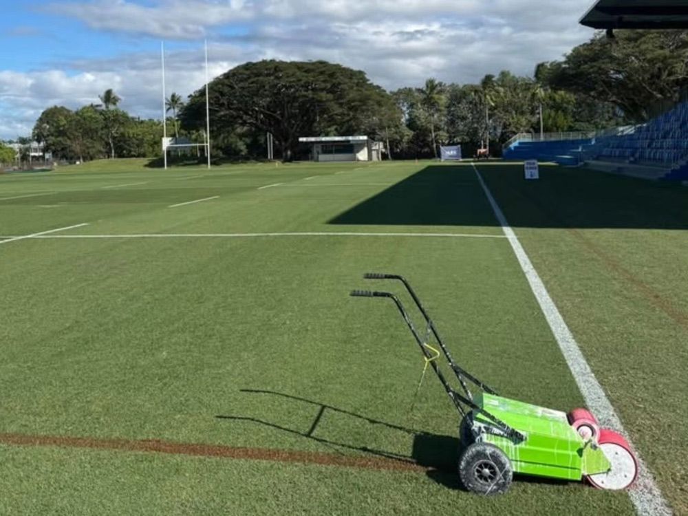 Green Line-Marking Machine on A Sports Field Near the Sideline Under a Partly Cloudy Sky — Tropical Lawns in Mulgrave, QLD