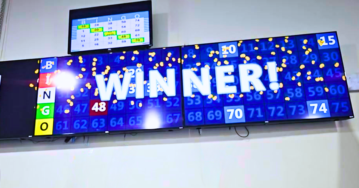 A sign that says `` winner '' is hanging on a wall.