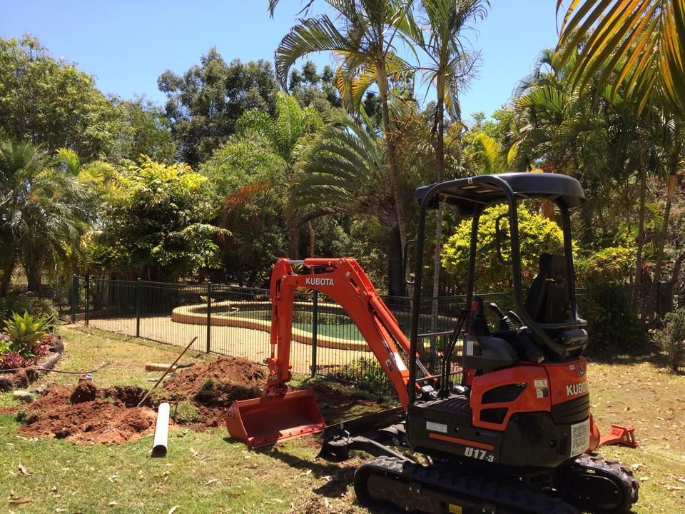 Orange Kubota Mini Excavator Near a Pool — Langley Plumbing in Mareeba, QLD
