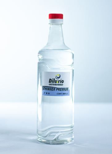 Botella de vidrio transparente de desinfectante “Diluvio” con tapa roja.