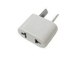 Adaptador de viaje blanco con enchufe estadounidense de dos clavijas y toma de corriente universal.