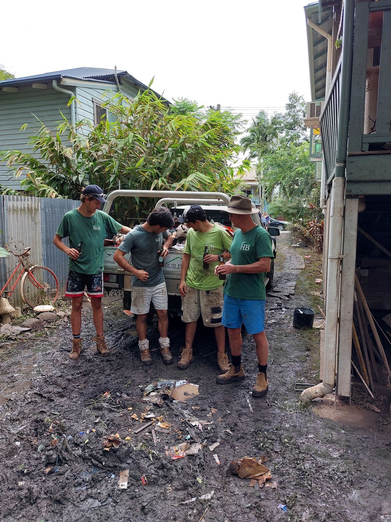 A group of men are standing in front of a house.