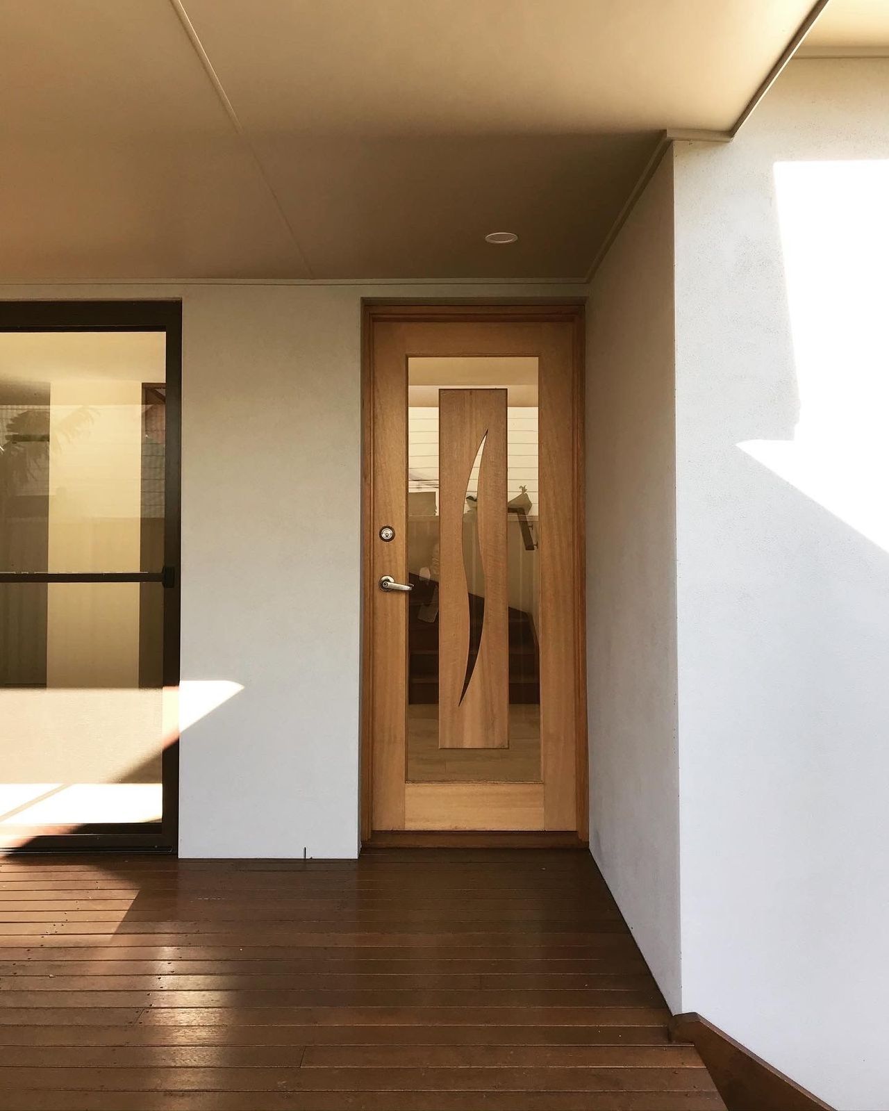 A wooden door with a glass window in a house