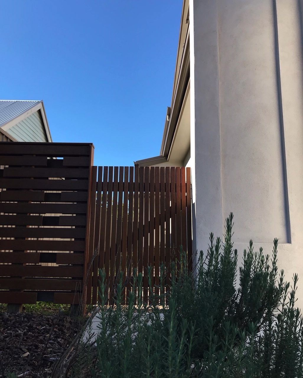 A white building with a wooden fence in front of it