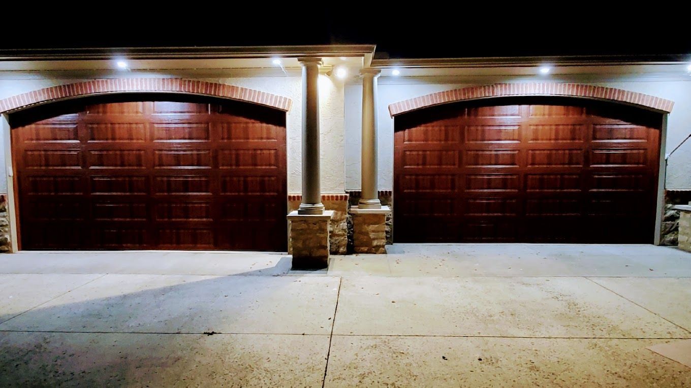 A couple of garage doors are sitting next to each other in a driveway.