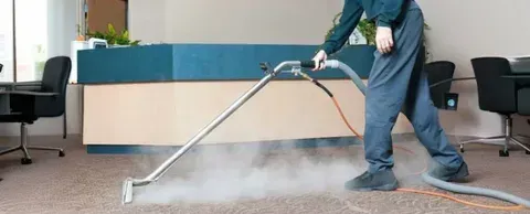 eam extraction carpet cleaning being performed in a commercial office space with a reception desk in the background.