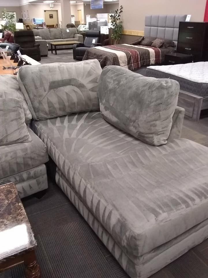 a large sectional couch in a furniture store