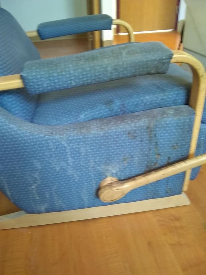 a close up of a blue chair cushion on a wooden floor
