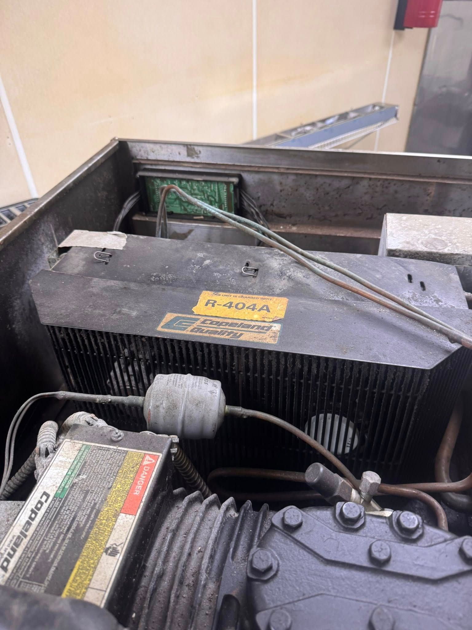 Close-up of an engine bay with black radiator and hoses inside a vehicle compartment