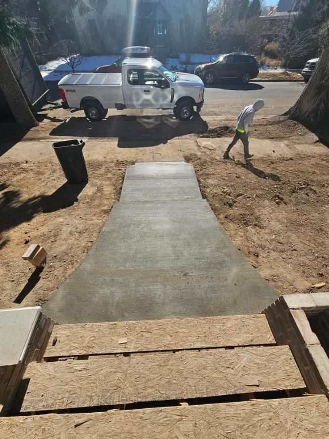 Newly poured concrete ramp leading to a house. 
