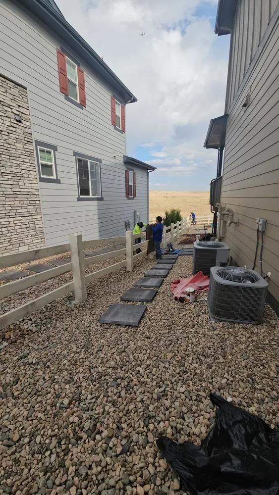 Two-story houses with a path and fence.