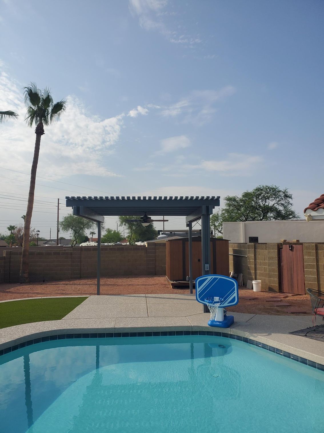 Southwest Patio's team expertly installing a high-quality patio cover, transforming a Phoenix home's outdoor space.