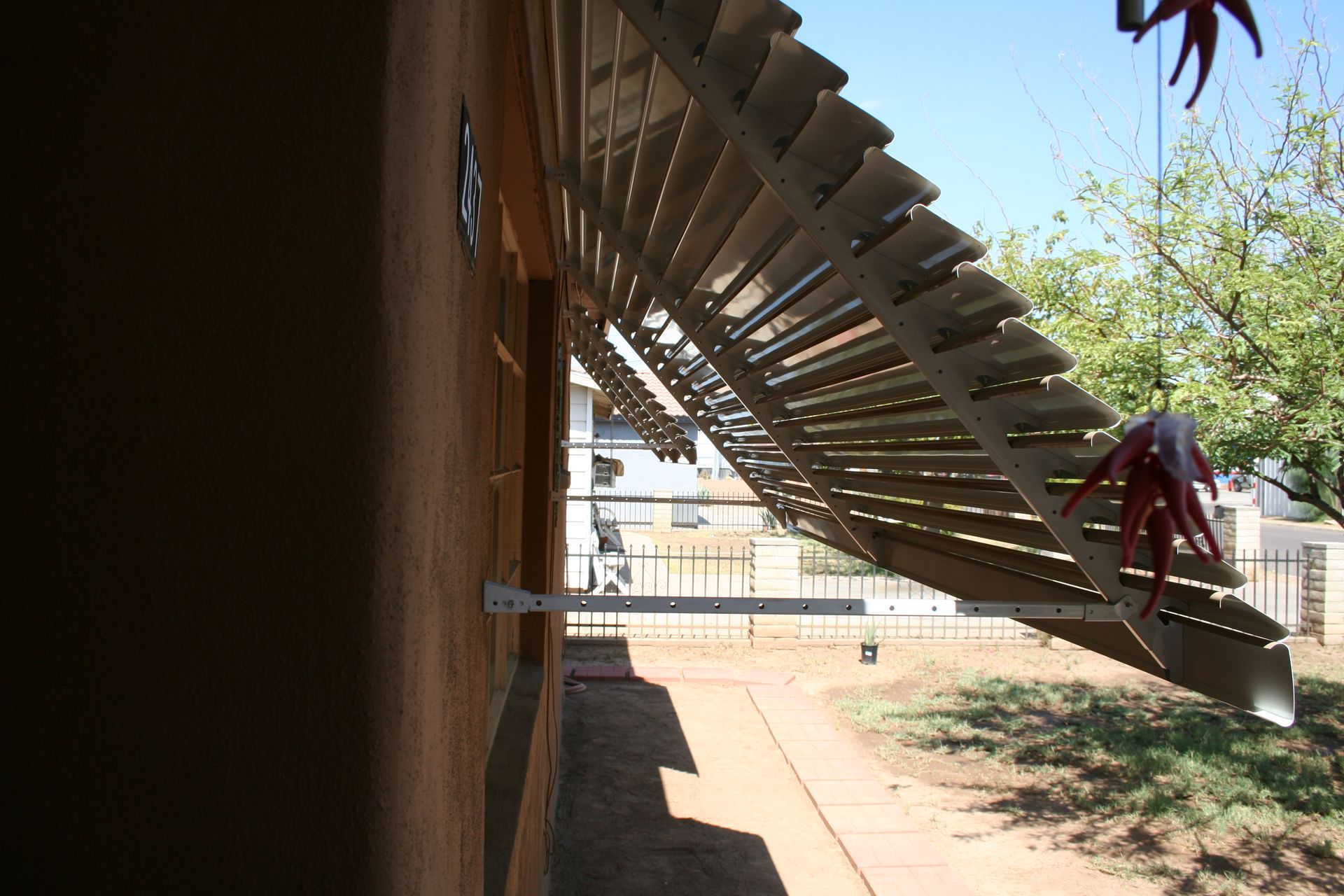Colorful window awnings installed in Mesa, AZ, enhancing home exterior while reducing indoor heat.