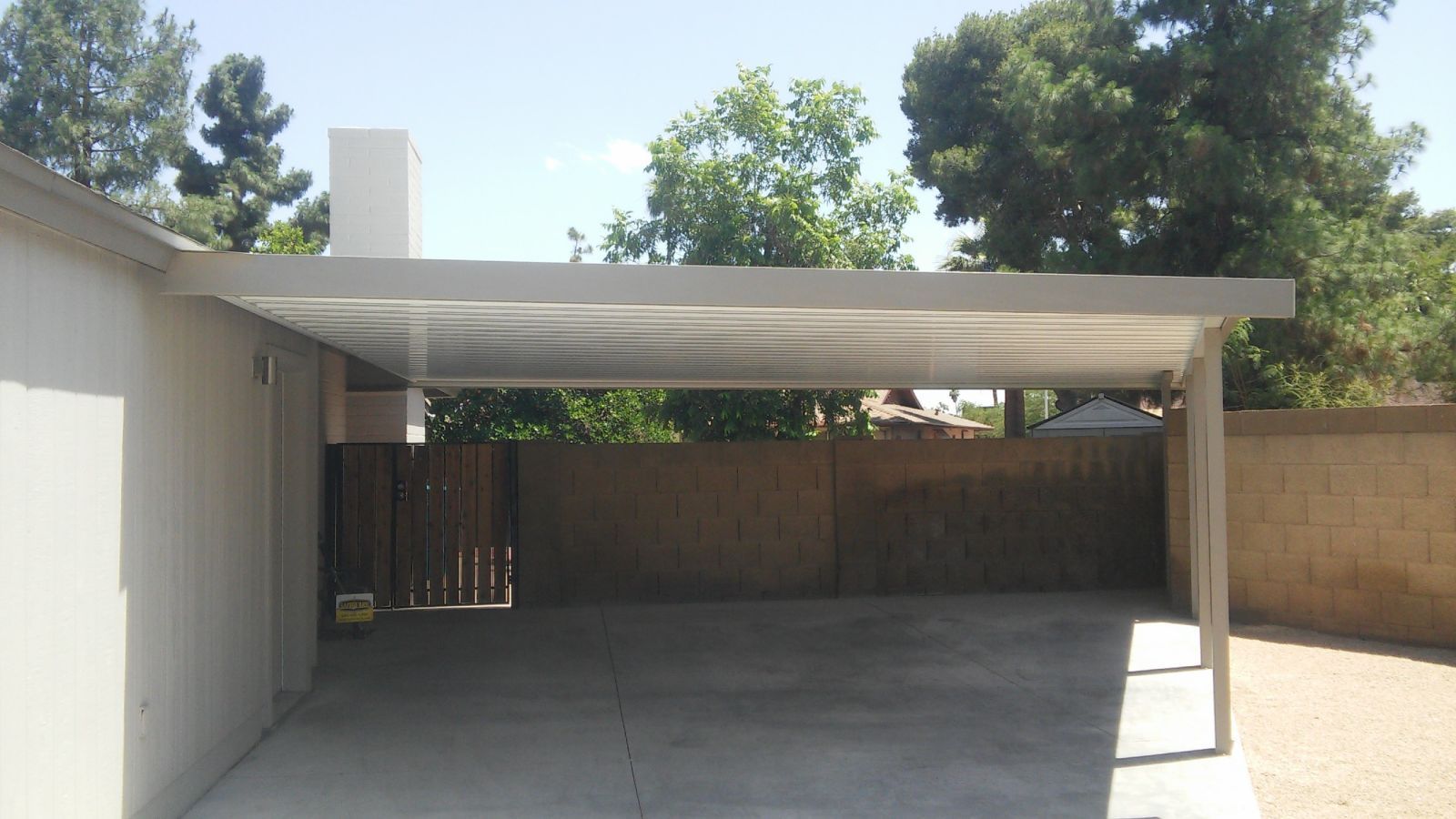 Robust 'W' Style Pan Carport Cover installed in Phoenix, offering durable protection for vehicles against the Arizona sun.