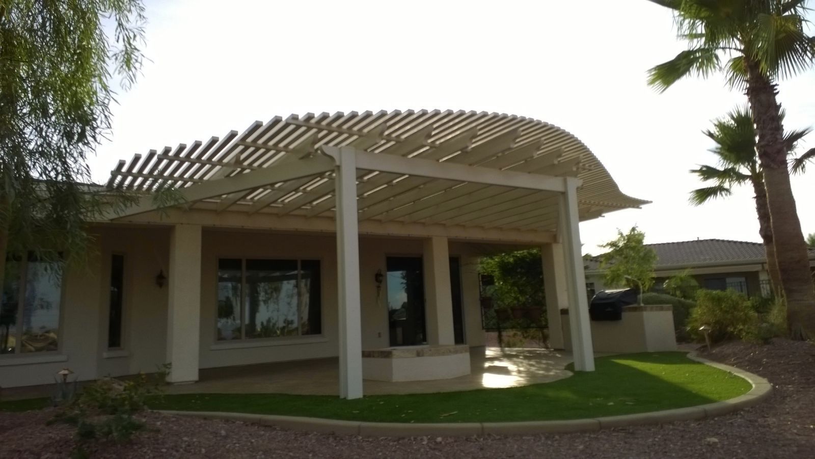 lattice style patio cover giving shade on back patio