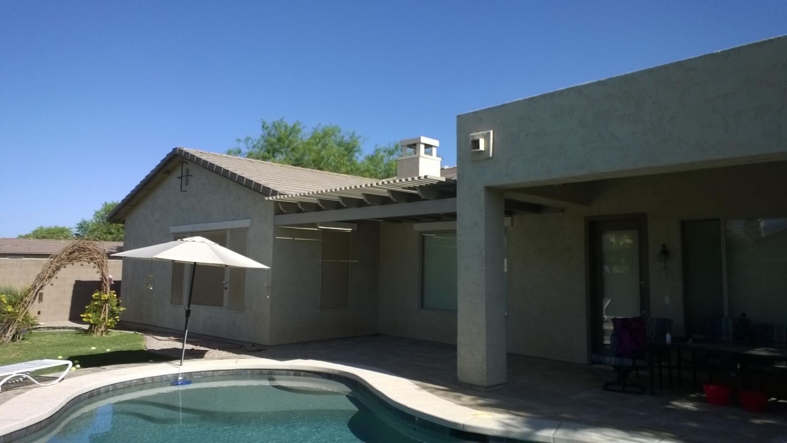 Custom-crafted lattice patio cover in Tempe, offering a blend of shade and sunlight for ideal outdoor comfort.