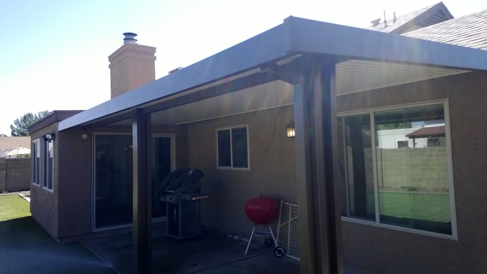 New River homes enjoy expanded living spaces under Southwest Patio's Flat Pan Covers.