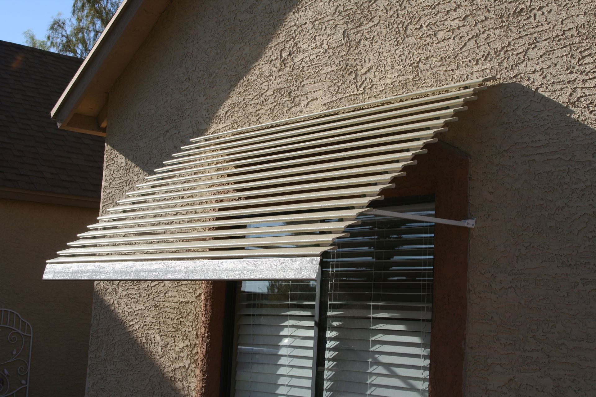 Custom window awnings from Southwest Patio, transforming and cooling Phoenix, AZ home interiors.