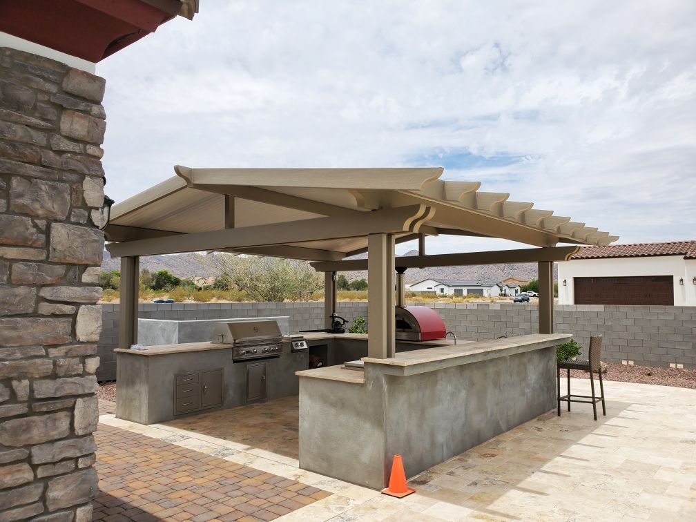 Spacious outdoor entertainment area in Gilbert, AZ, shaded by a Southwest Patio gabled roof cover.