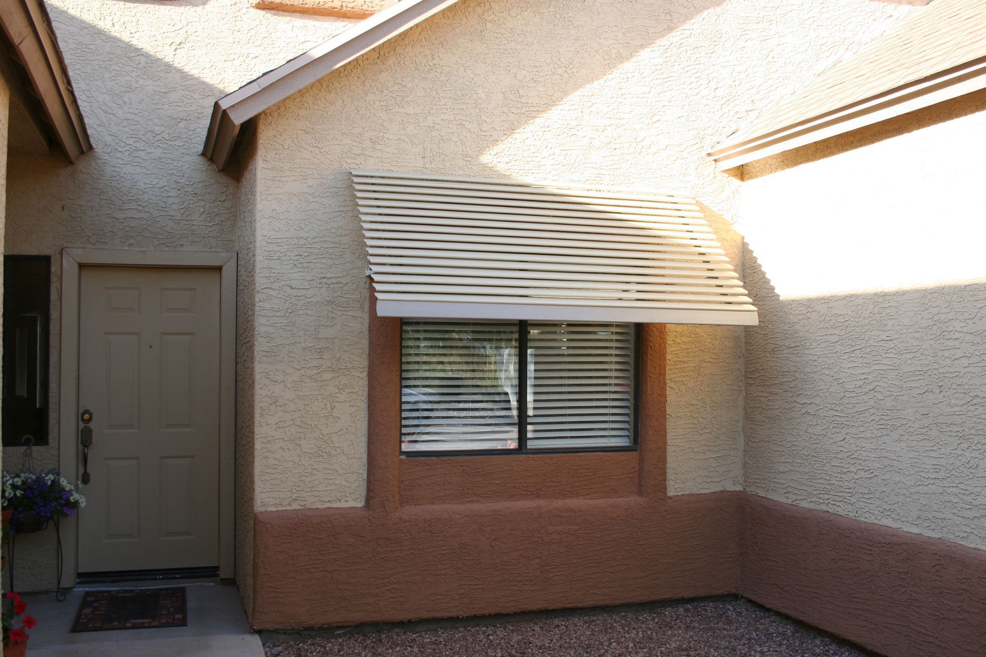 Stylish window awning by Southwest Patio, adding curb appeal and sun protection to a Phoenix residence.