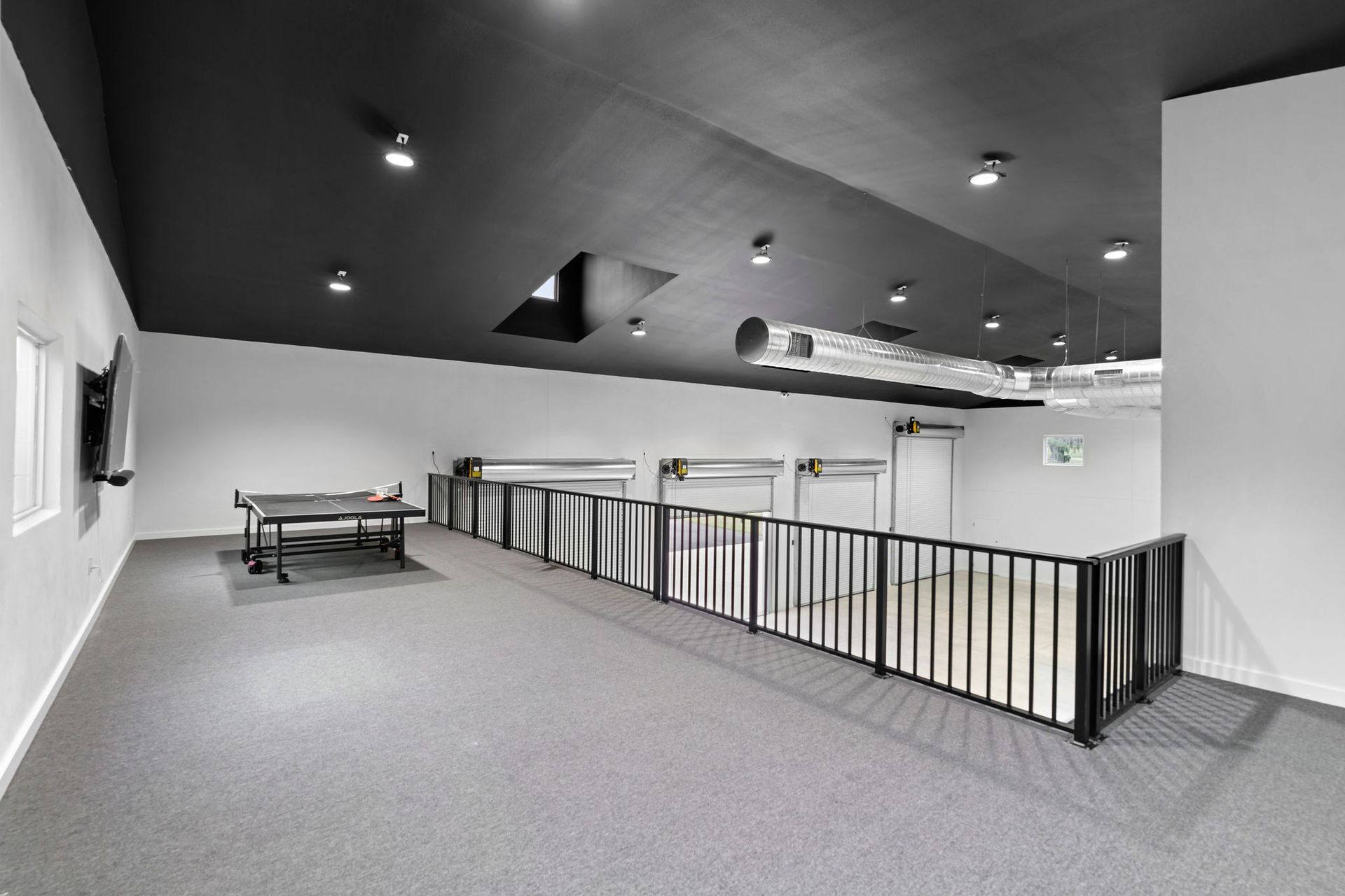 There is a ping pong table in the middle of the room.