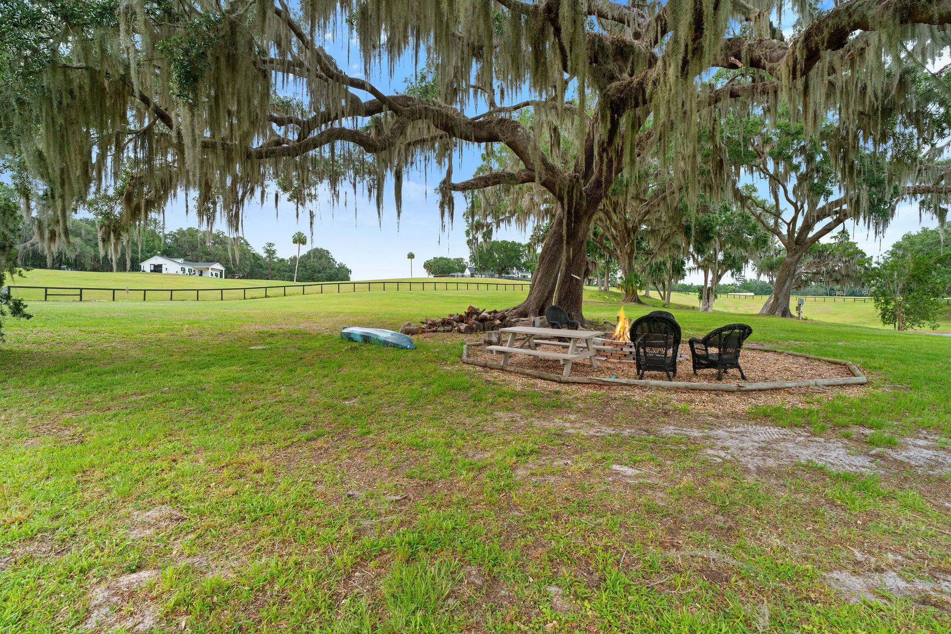 There is a fire pit in the middle of a grassy field.