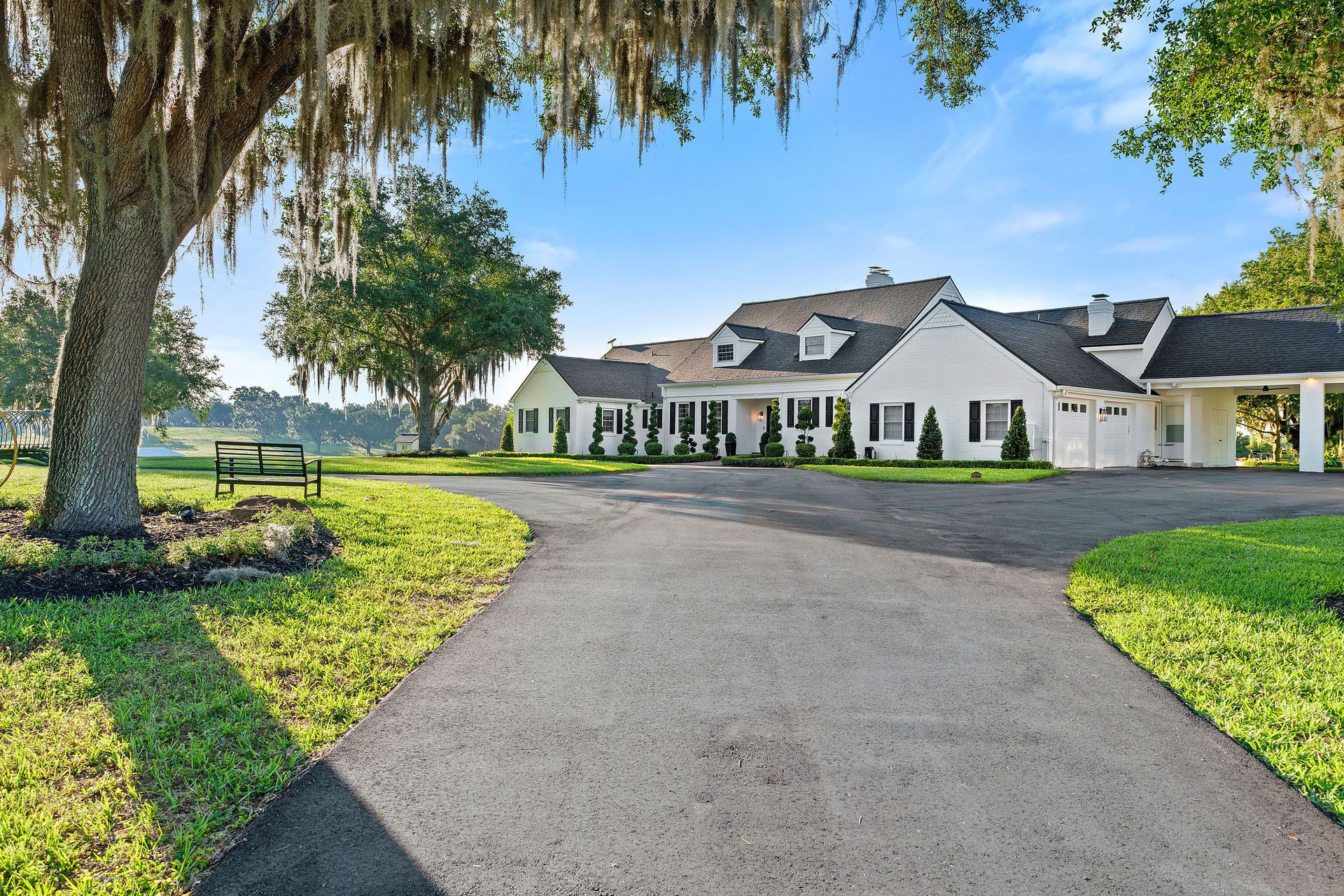 A large white house with a driveway leading to it