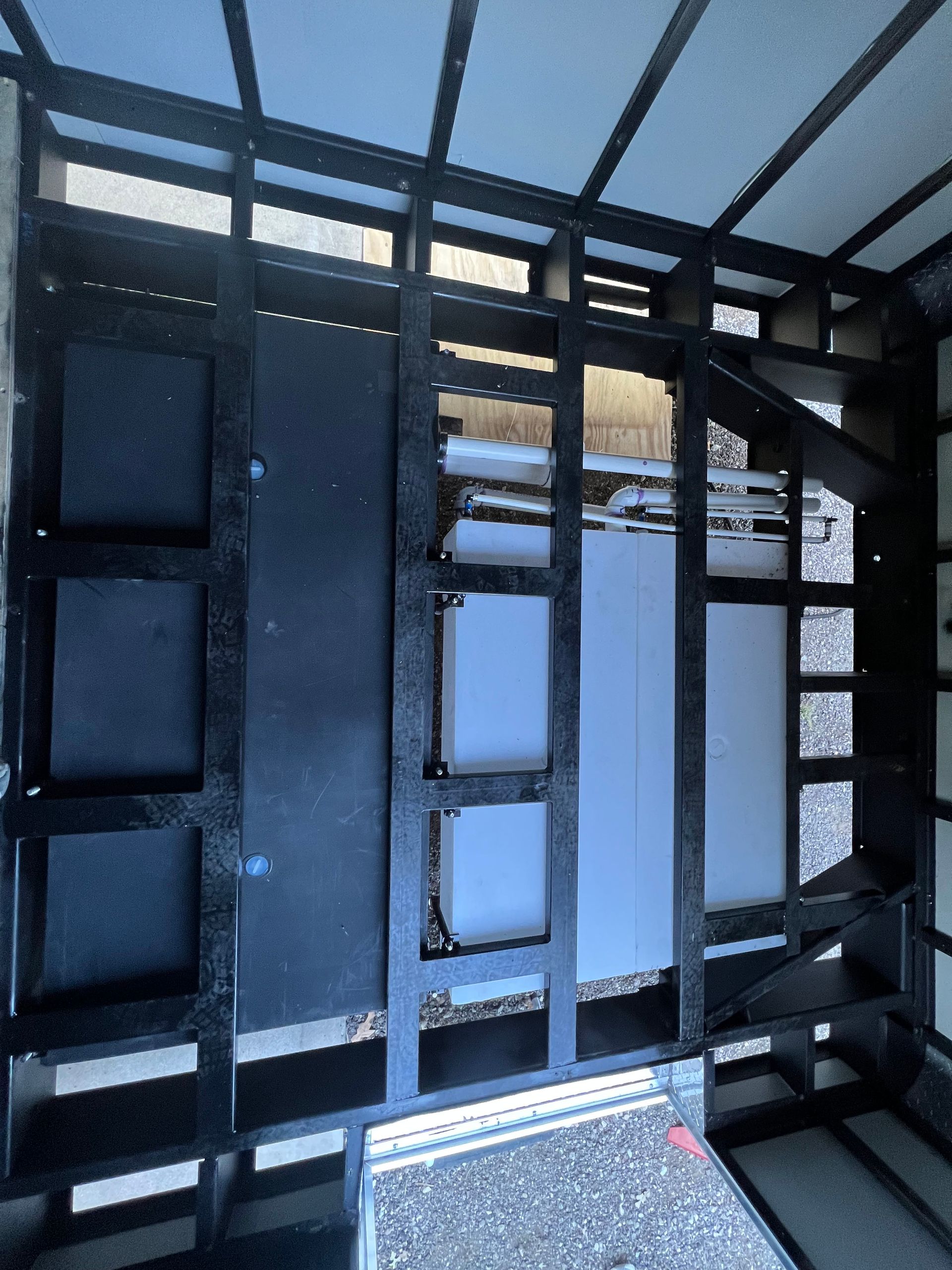 Frame of cargo trailer and wall panels during upgrade showing window openings