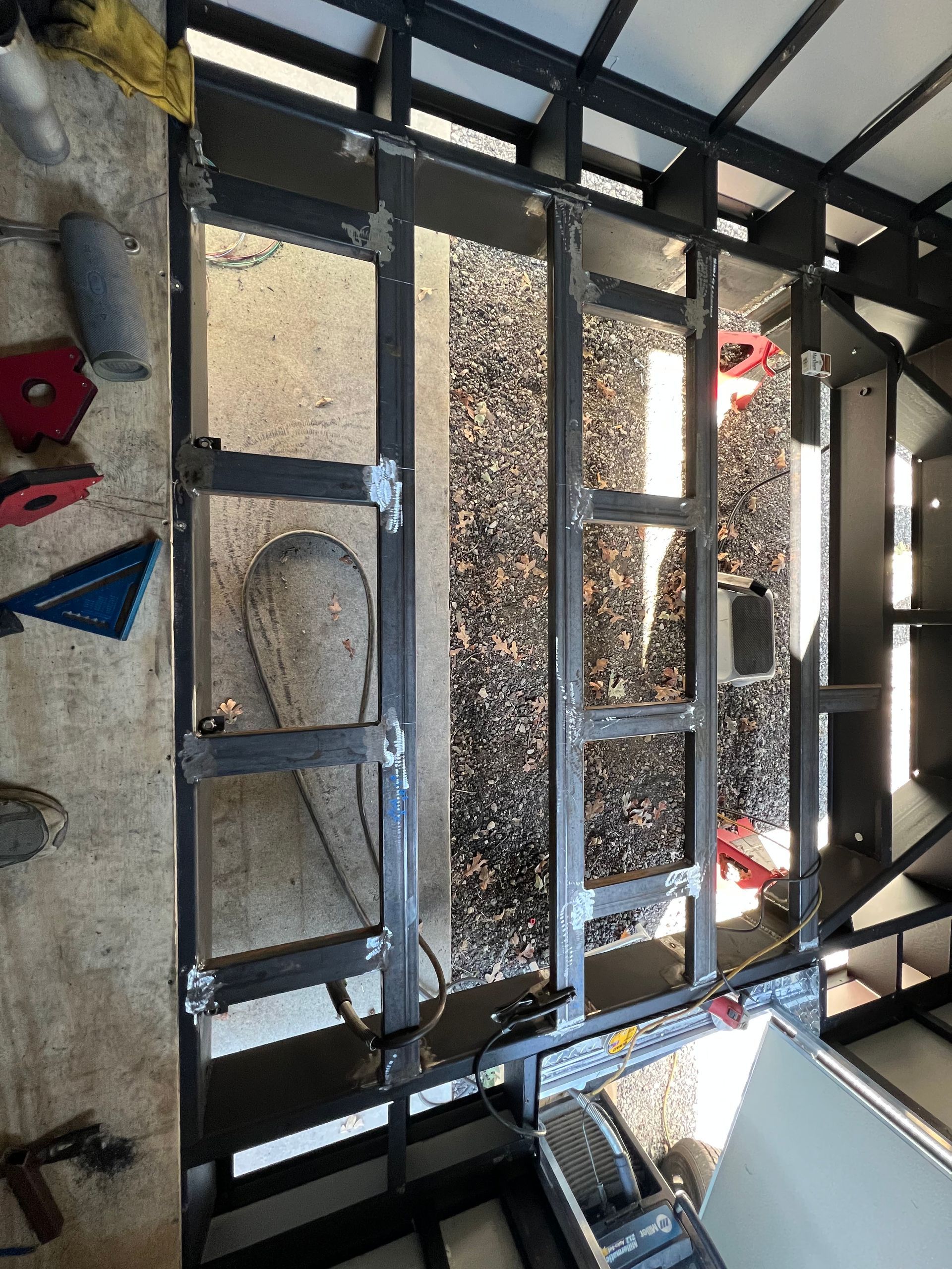 Frame of cargo trailer and wall panels during upgrade showing welding