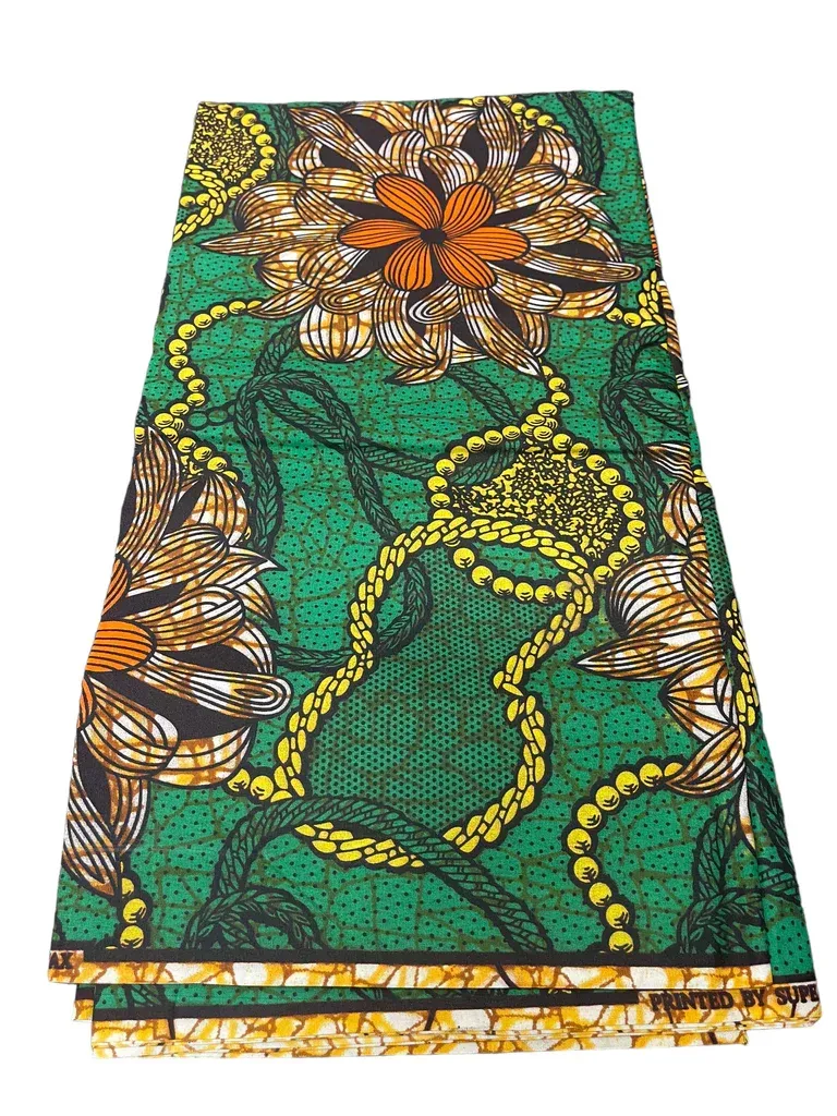 Folded green patterned fabric with yellow and orange floral designs