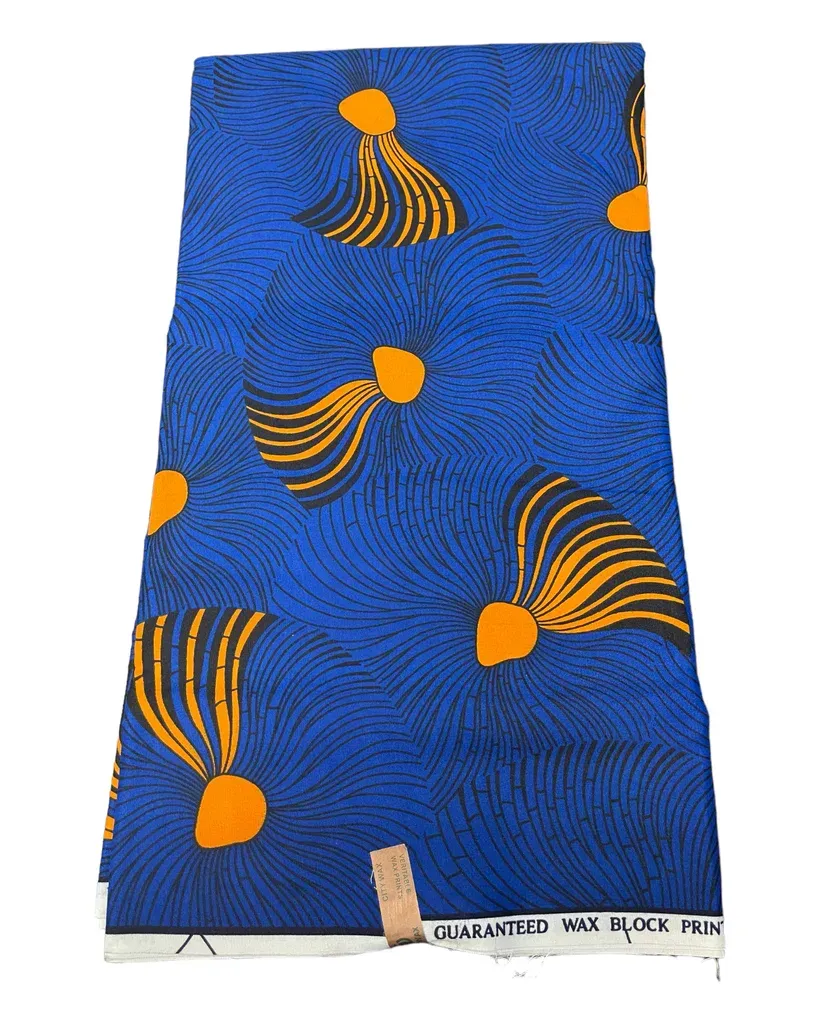 Blue fabric with orange abstract shell-like patterns and swirls, hanging vertically