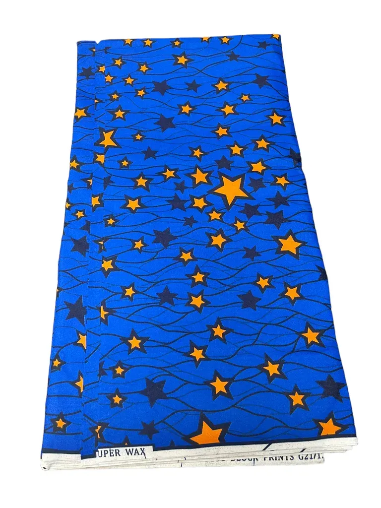 Blue fabric with orange stars and dark blue pattern, laid flat and tapered at the bottom