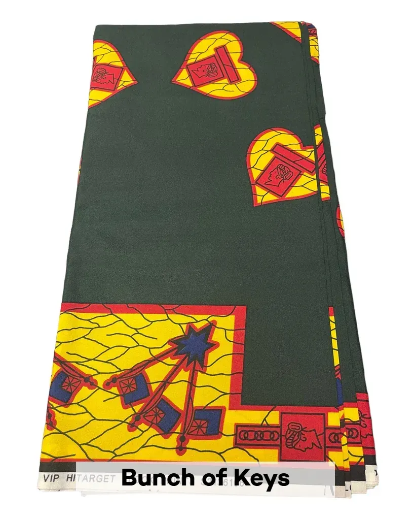 Dark green patterned rug with red and yellow geometric shapes and border, labeled 