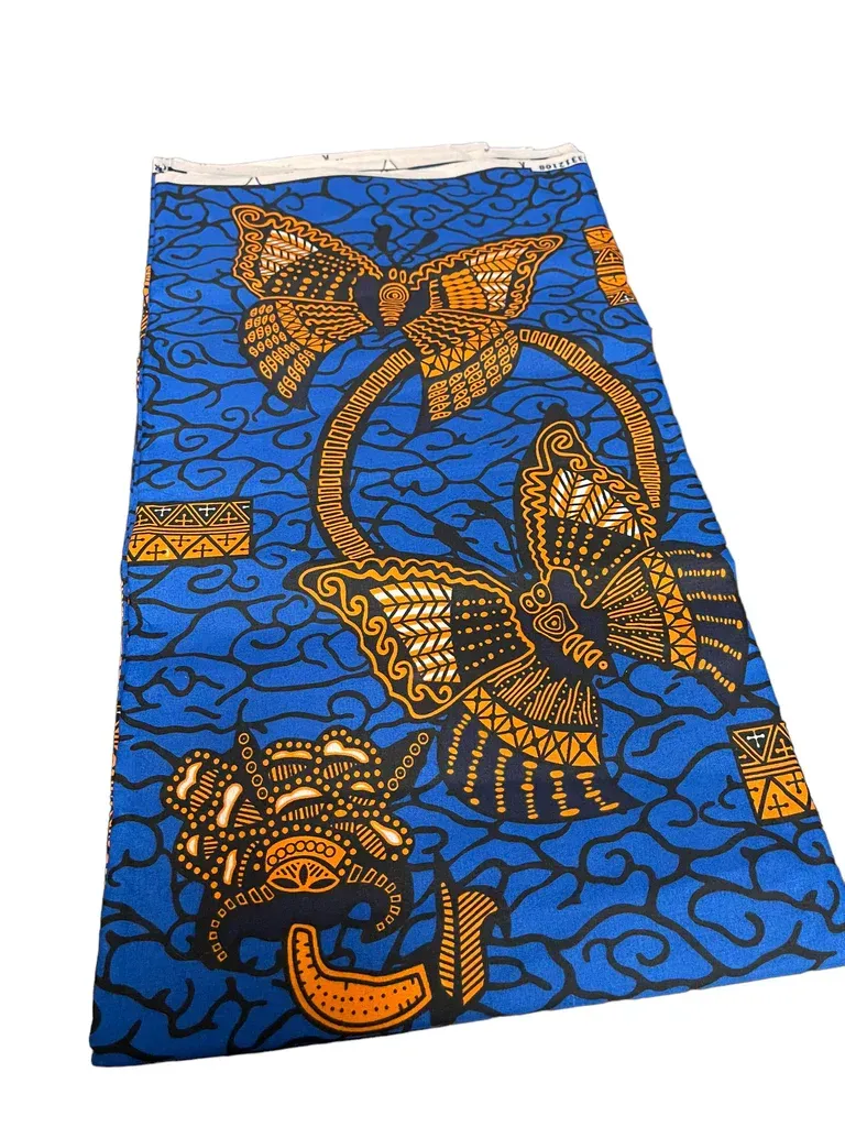 Blue patterned fabric with orange and black floral and butterfly designs