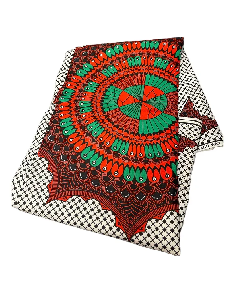 Red and green patterned blanket or cloth draped over a white surface