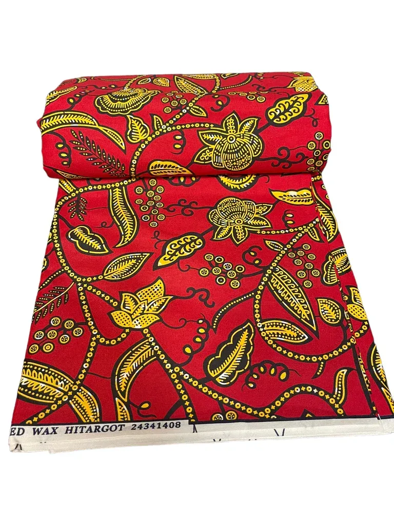 Red and yellow patterned folded fabric pouch with a flap closure